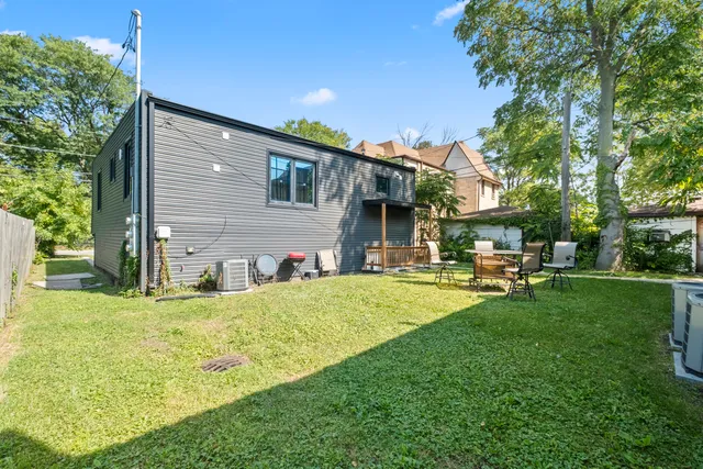 a view of a house with a yard patio and sitting area