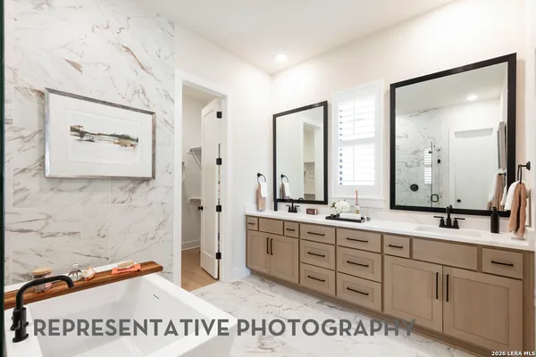 a bathroom with a sink a mirror and a shower