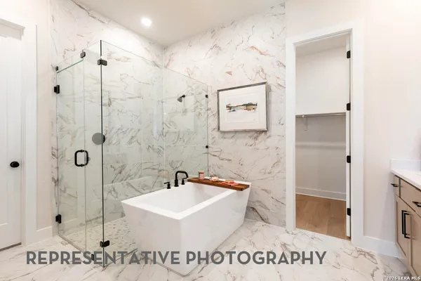 a bathroom with a sink a mirror and a shower