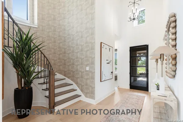 a view of a hallway with wooden floor and windows