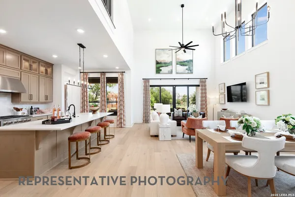 a living room with furniture a flat screen tv and a large window