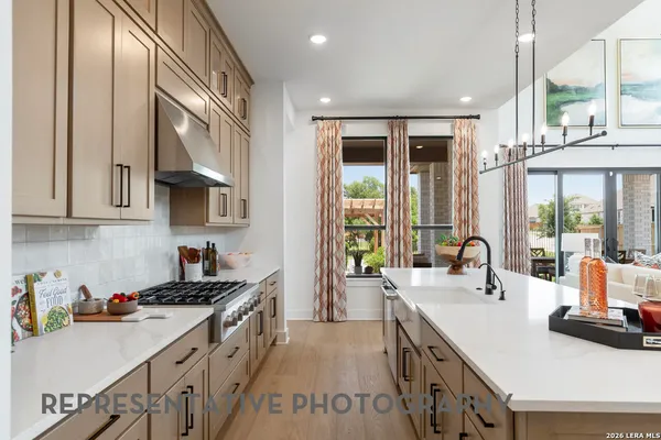 a kitchen with sink a stove and cabinets