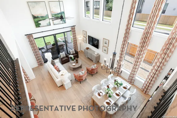 a living room with furniture and a floor to ceiling window