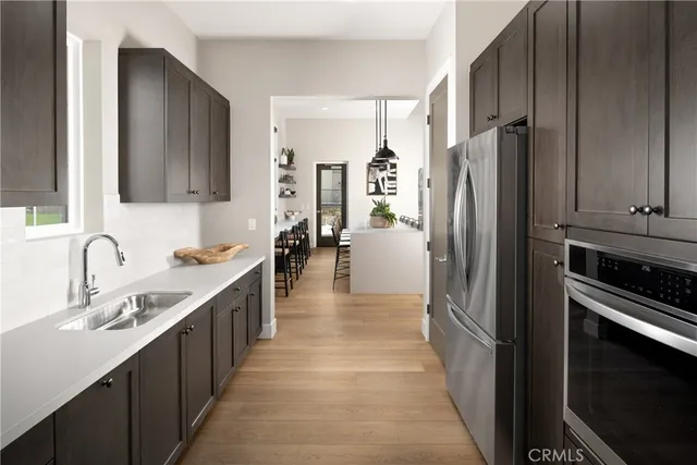 a kitchen with stainless steel appliances a refrigerator and a sink