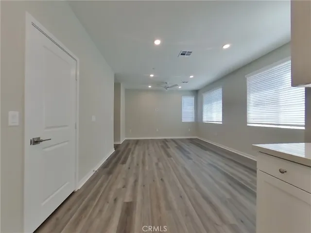 a view of hallway with a sink and wooden floor