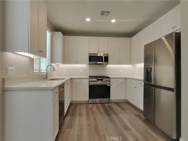 a kitchen with a refrigerator sink and stove