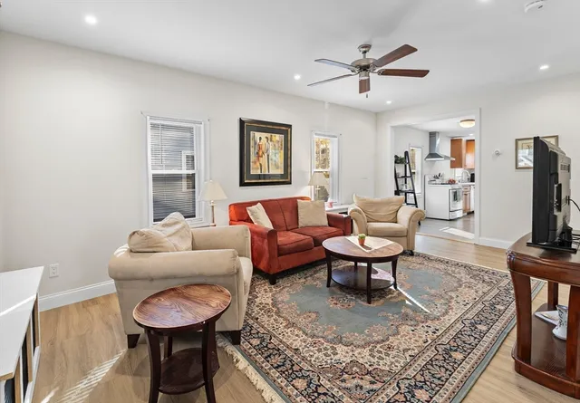 a living room with furniture a rug and a chandelier