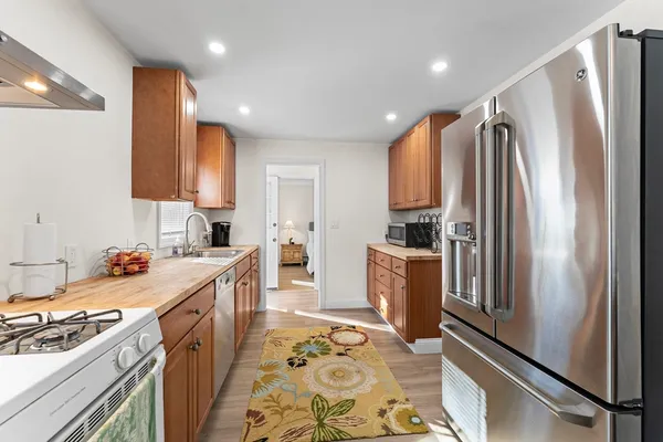 a kitchen with stainless steel appliances granite countertop a refrigerator sink and cabinets