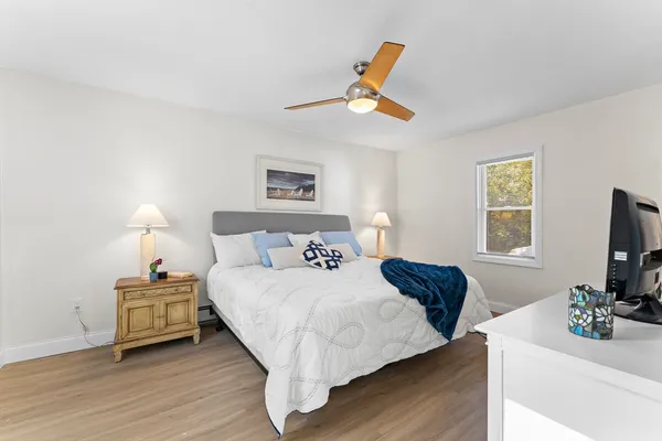 a bedroom with a bed and a flat screen tv