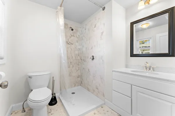a bathroom with a sink a toilet and mirror