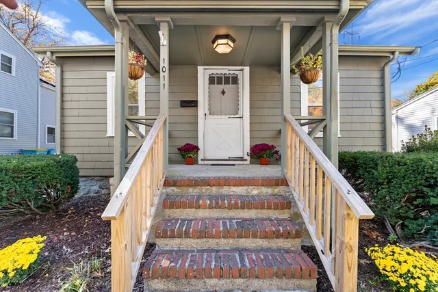 a front view of a house with wooden stairs