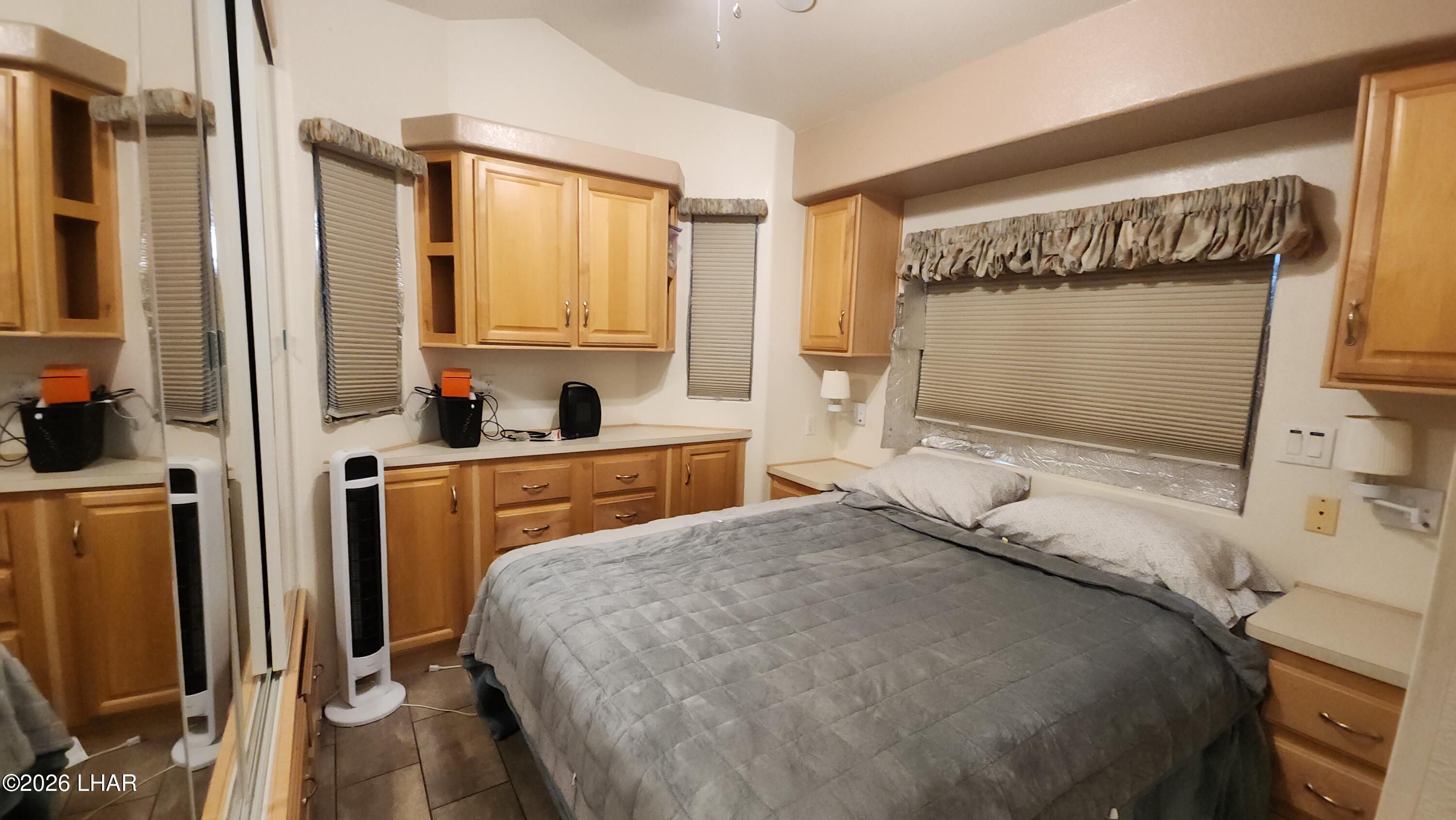 41 North Sagebrush Road Quartzsite, AZ 85346 - Photo 18 of 33 a bedroom with a bed next to a window with the outer view