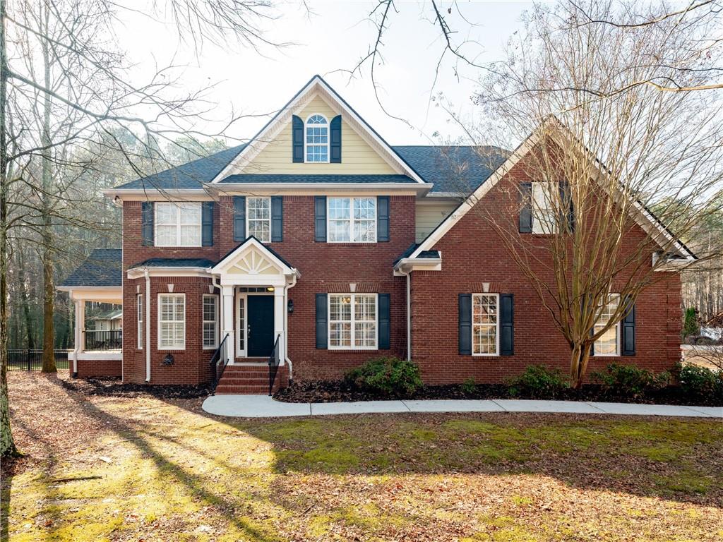 a front view of a house with a yard