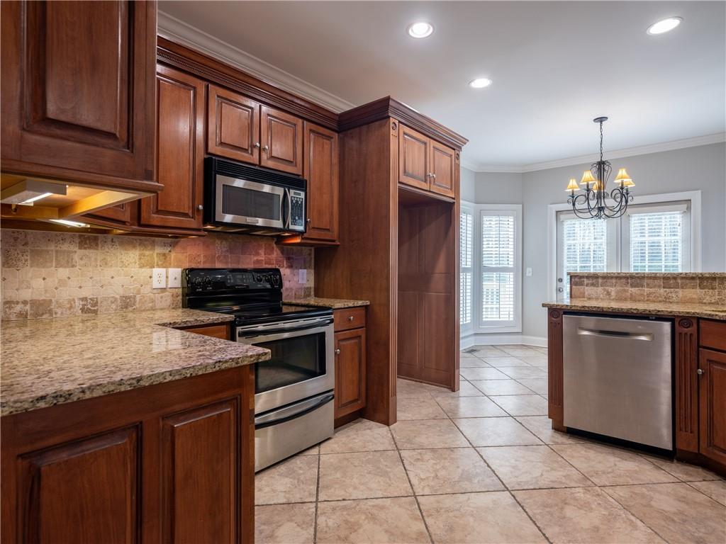 122 Caverns Way Northeast Calhoun, GA 30701 - Photo 15 of 56 a kitchen with stainless steel appliances granite countertop a stove a sink and a microwave