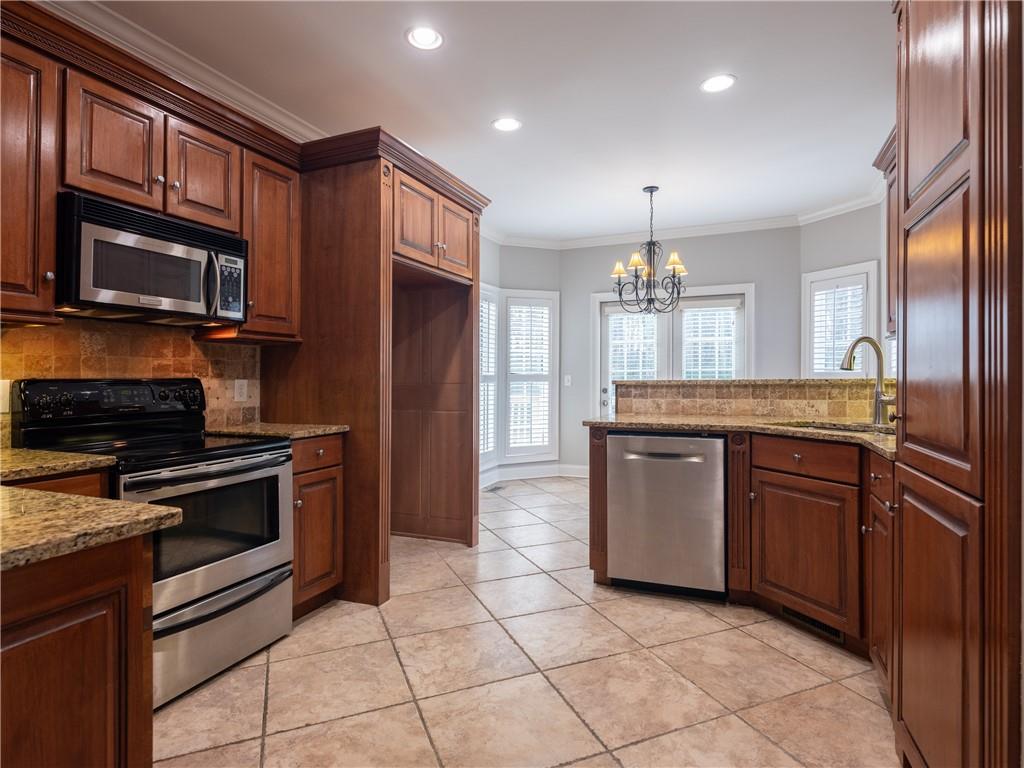 122 Caverns Way Northeast Calhoun, GA 30701 - Photo 16 of 56 a kitchen with stainless steel appliances granite countertop a stove cabinets and microwave