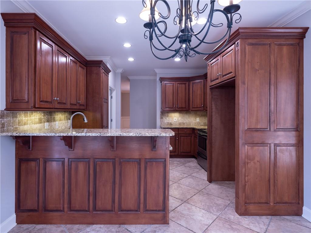122 Caverns Way Northeast Calhoun, GA 30701 - Photo 19 of 56 a kitchen with stainless steel appliances granite countertop wooden cabinets a counter top space and a sink