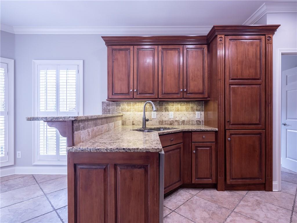 122 Caverns Way Northeast Calhoun, GA 30701 - Photo 20 of 56 a kitchen with granite countertop wooden cabinets and stainless steel appliances