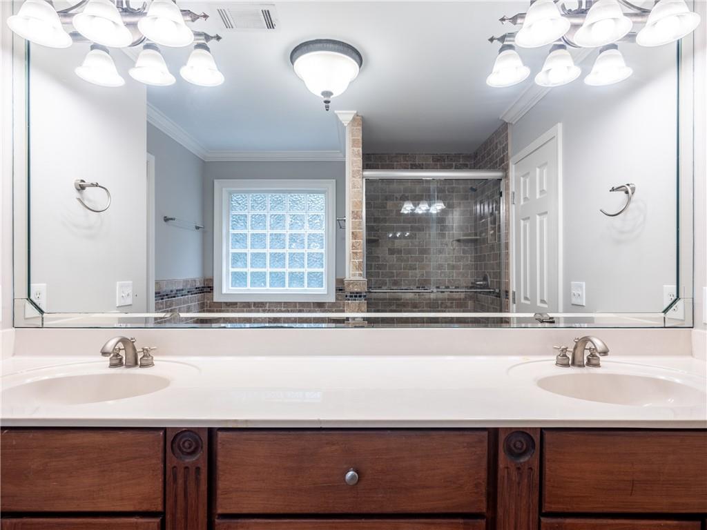 122 Caverns Way Northeast Calhoun, GA 30701 - Photo 35 of 56 a bathroom with a sink a large mirror and a light fixture