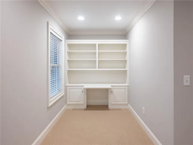 an empty room with windows and ceiling fan