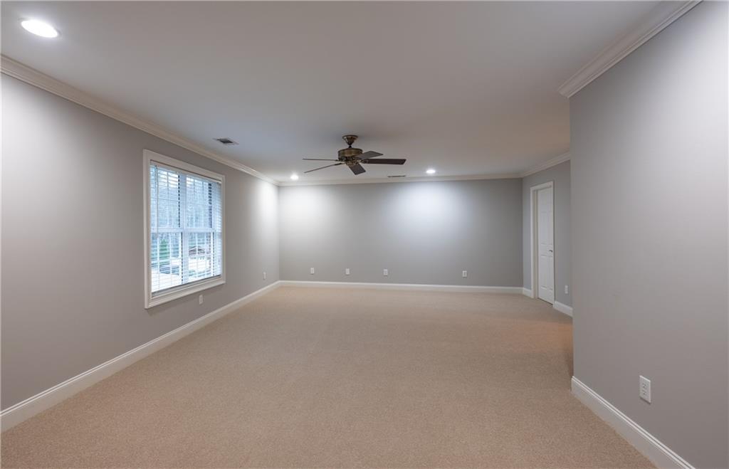 122 Caverns Way Northeast Calhoun, GA 30701 - Photo 53 of 56 an empty room with windows and ceiling fan