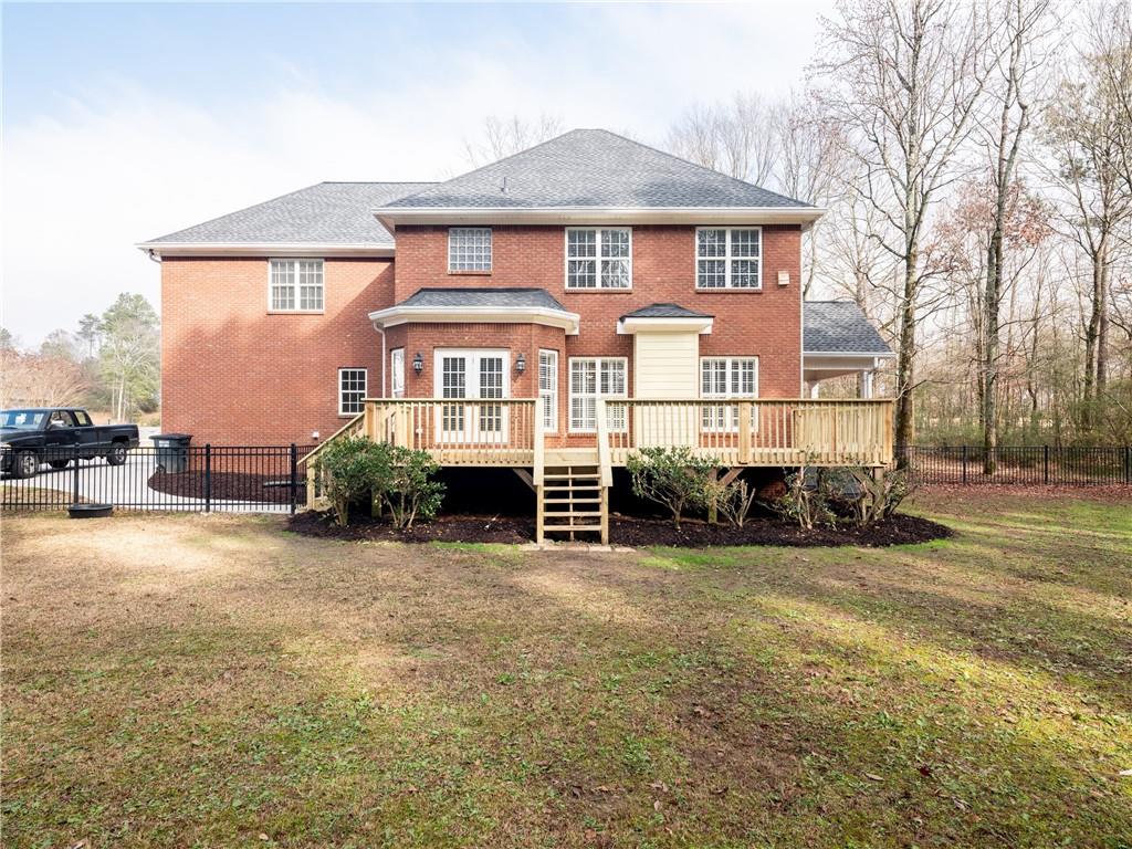 122 Caverns Way Northeast Calhoun, GA 30701 - Photo 55 of 56 a view of a house with a big yard and large trees