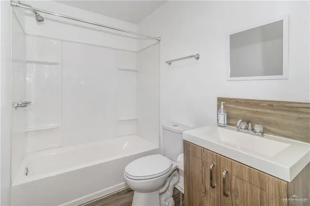 a view of a room with wooden floor