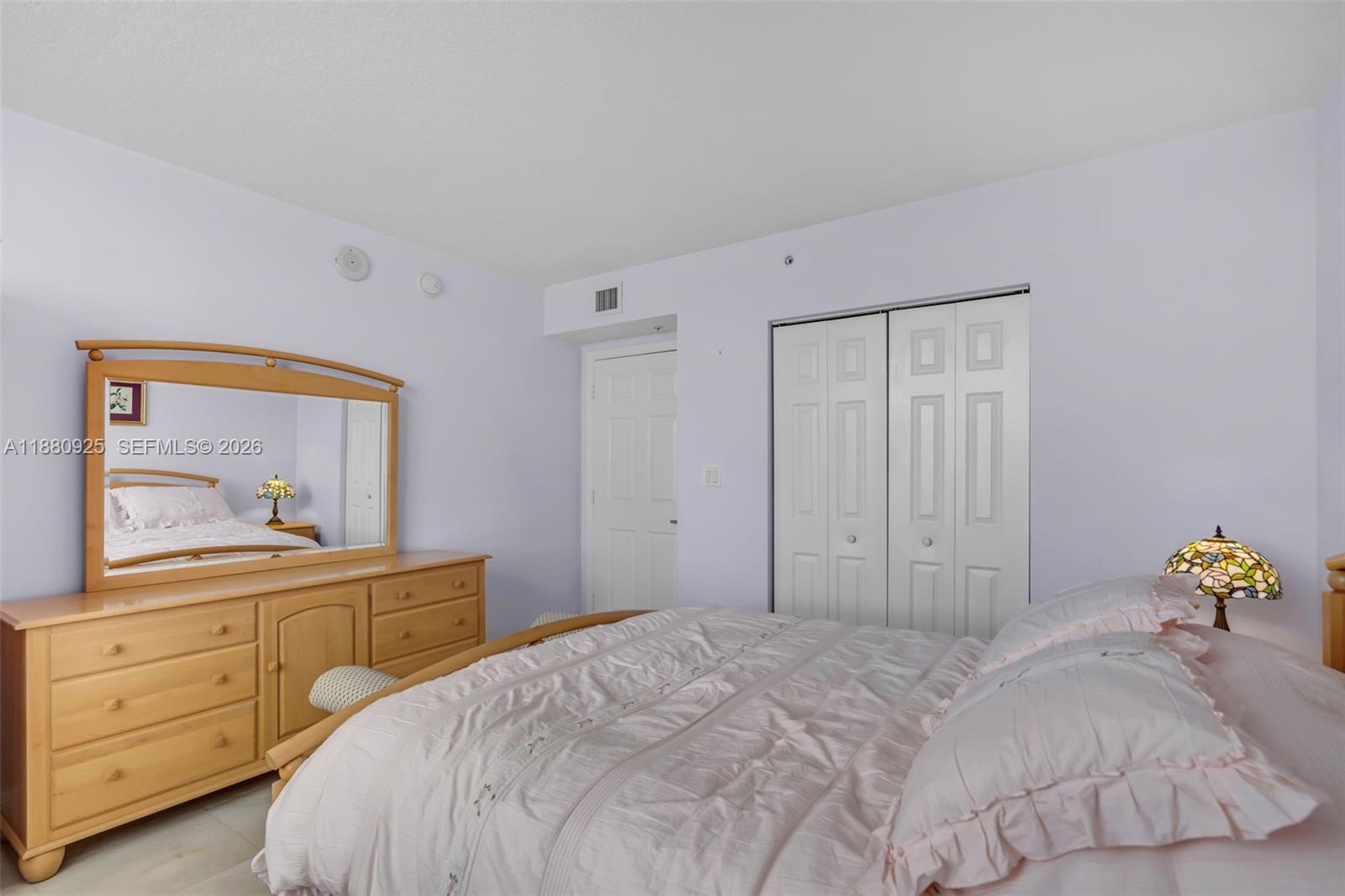 3232 Southwest 22nd Terrace, Unit 801 Miami, FL 33145 - Photo 11 of 23 a bedroom with a bed and a dresser