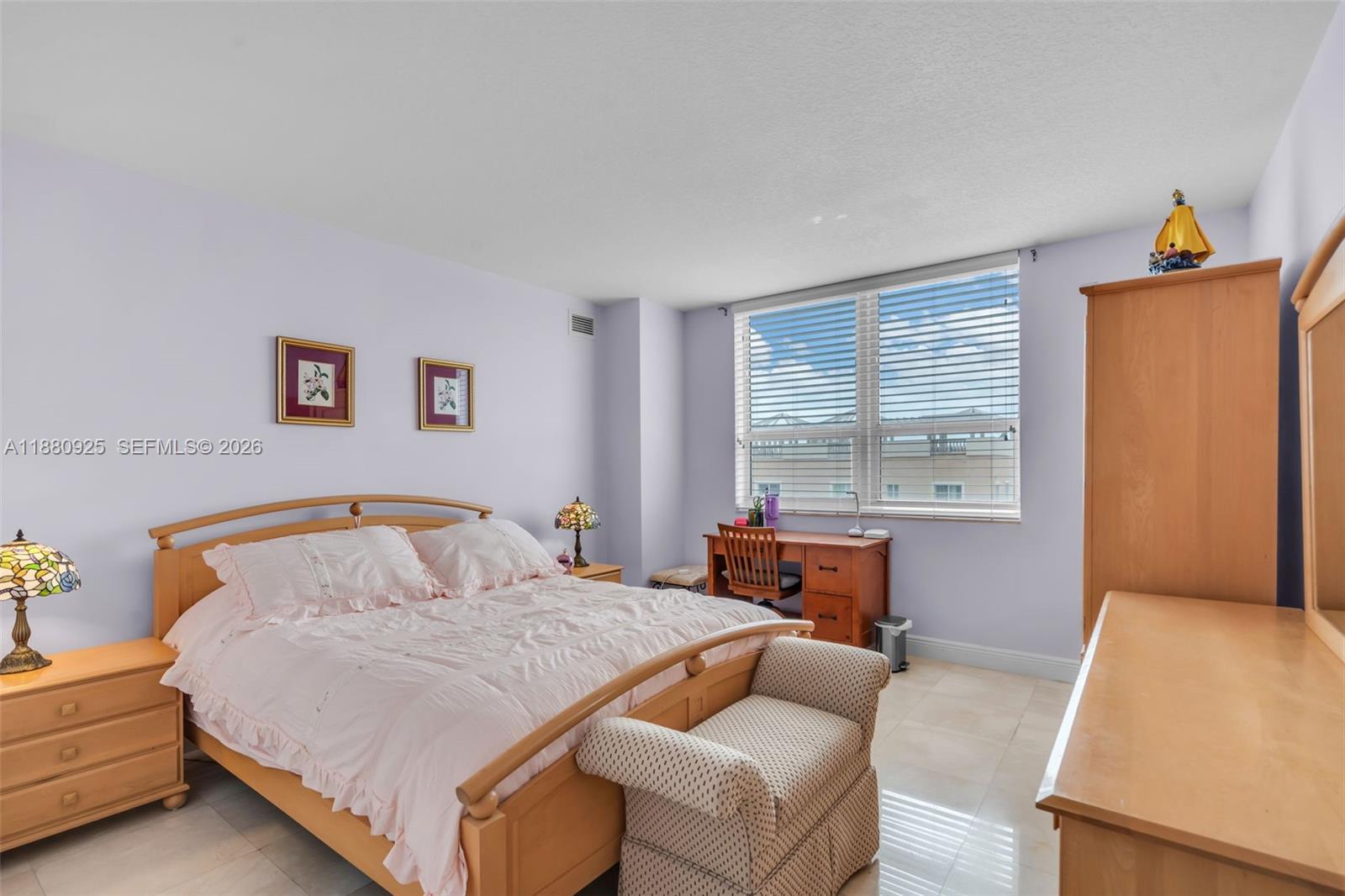 3232 Southwest 22nd Terrace, Unit 801 Miami, FL 33145 - Photo 12 of 23 a bedroom with a bed and wooden floor