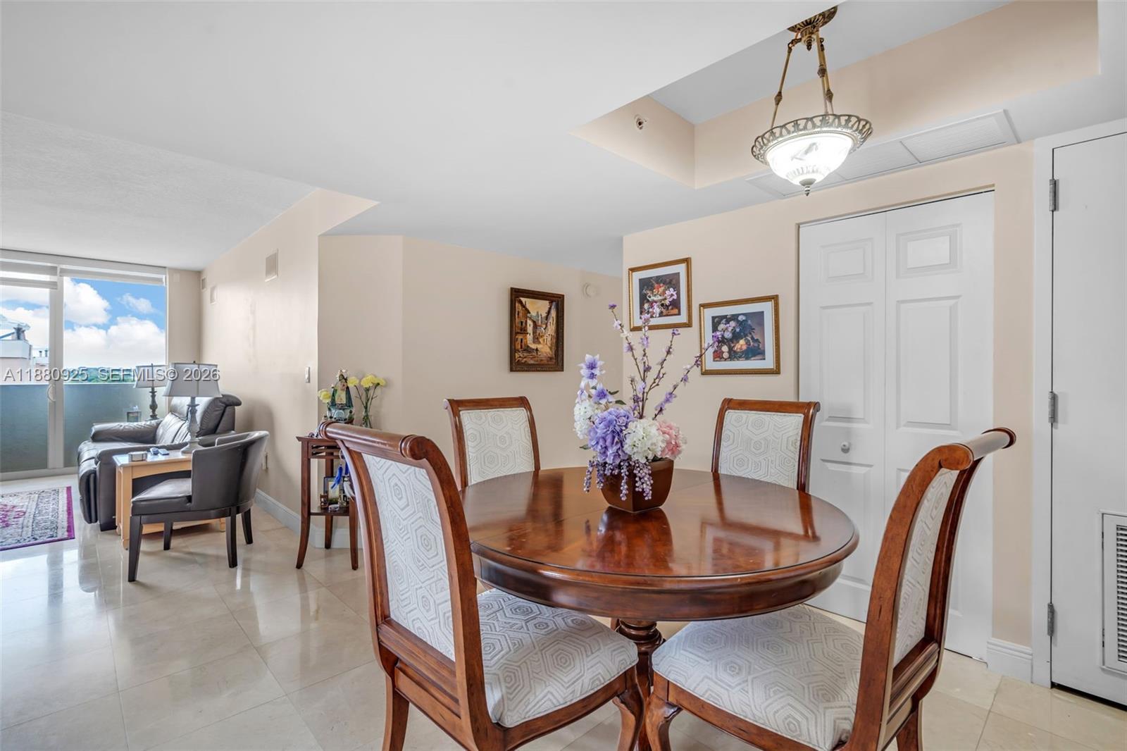 3232 Southwest 22nd Terrace, Unit 801 Miami, FL 33145 - Photo 4 of 23 a view of a dining room with furniture and chandelier