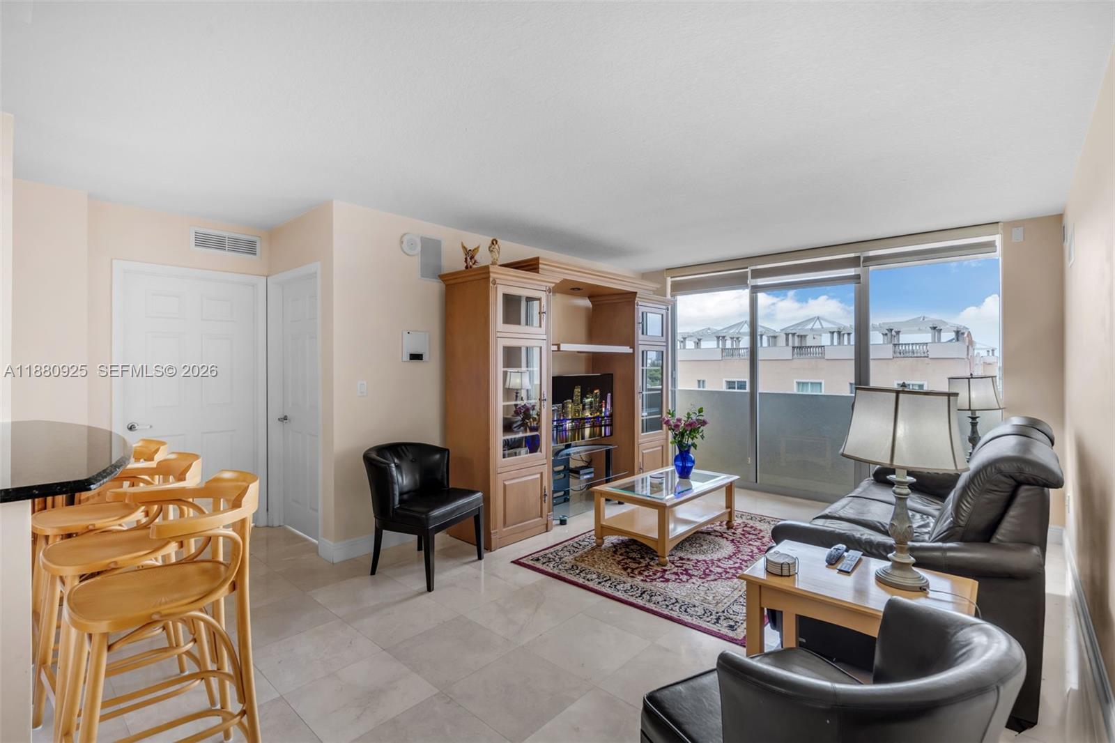 3232 Southwest 22nd Terrace, Unit 801 Miami, FL 33145 - Photo 6 of 23 a living room with furniture and a floor to ceiling window