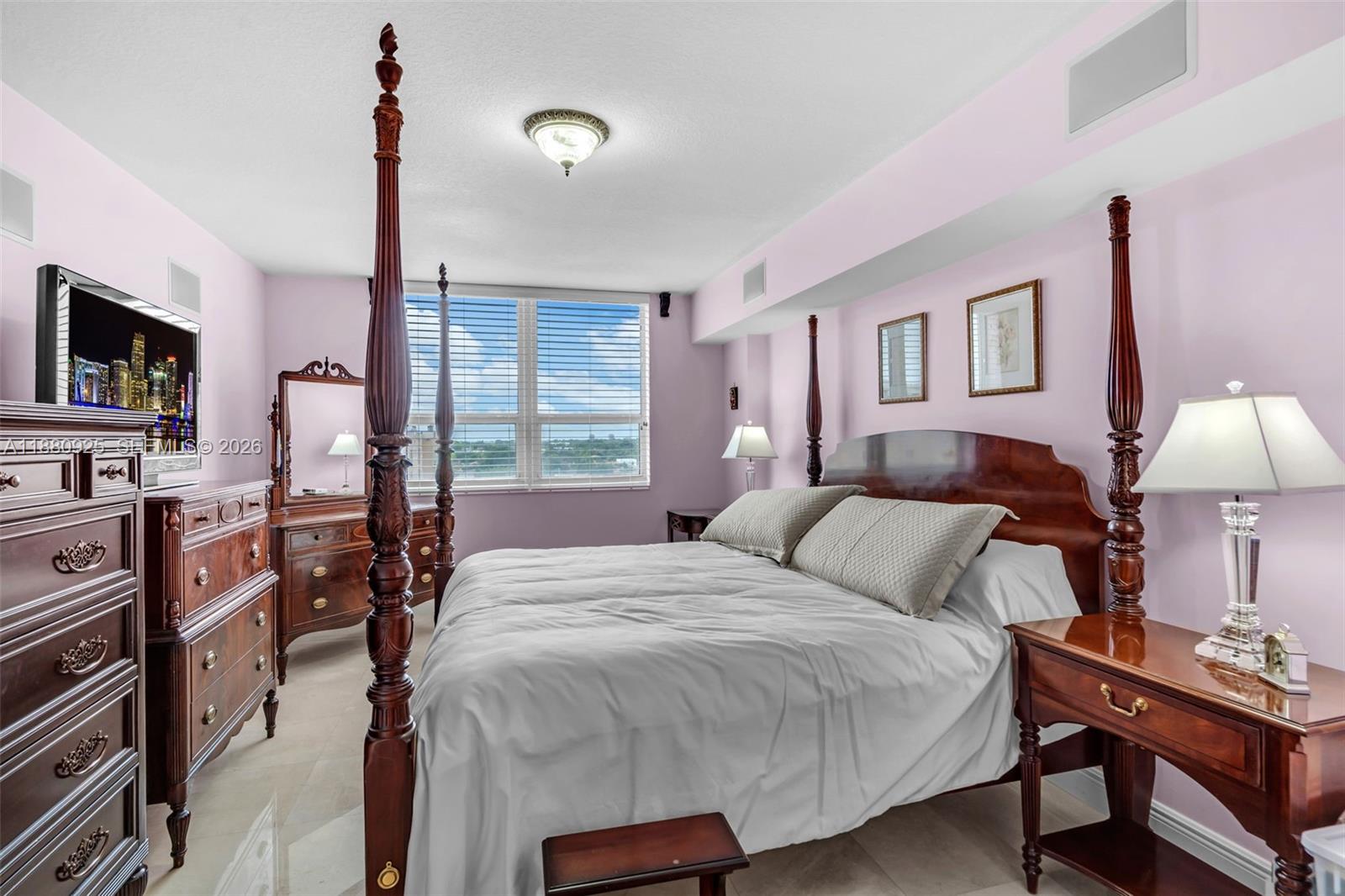 3232 Southwest 22nd Terrace, Unit 801 Miami, FL 33145 - Photo 8 of 23 a bedroom with a bed window and a flat screen tv