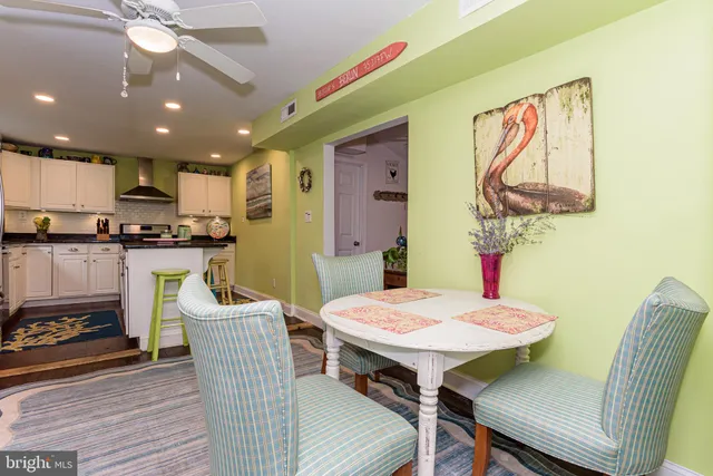 a bedroom with a bed and a dresser next to a window