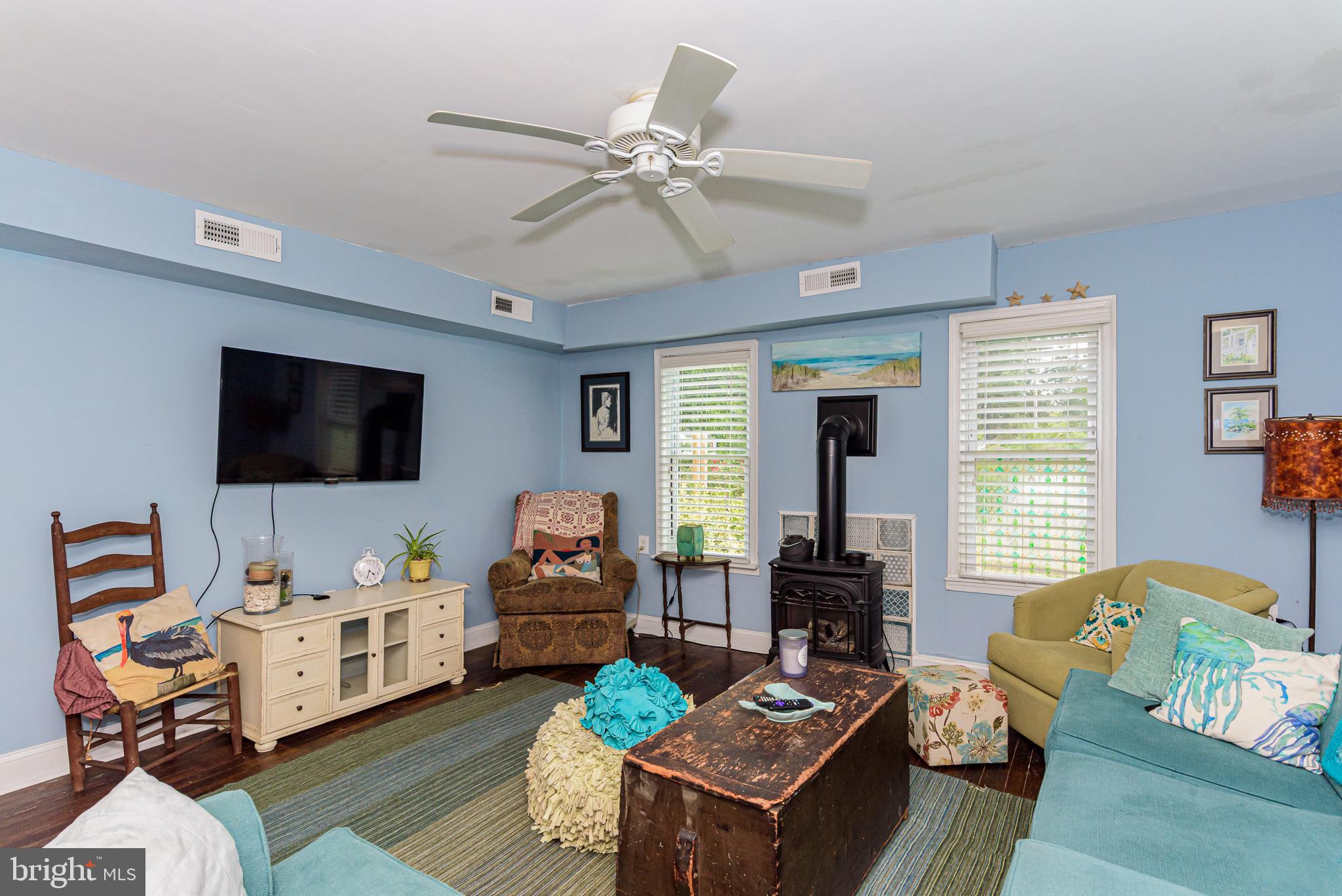 10213 Germantown Road Berlin, MD 21811 - Photo 30 of 118 a living room with furniture and a flat screen tv