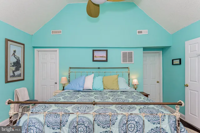 a backyard of a house with plants and large tree