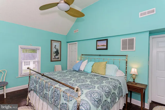 a view of a backyard with a bench and a large tree