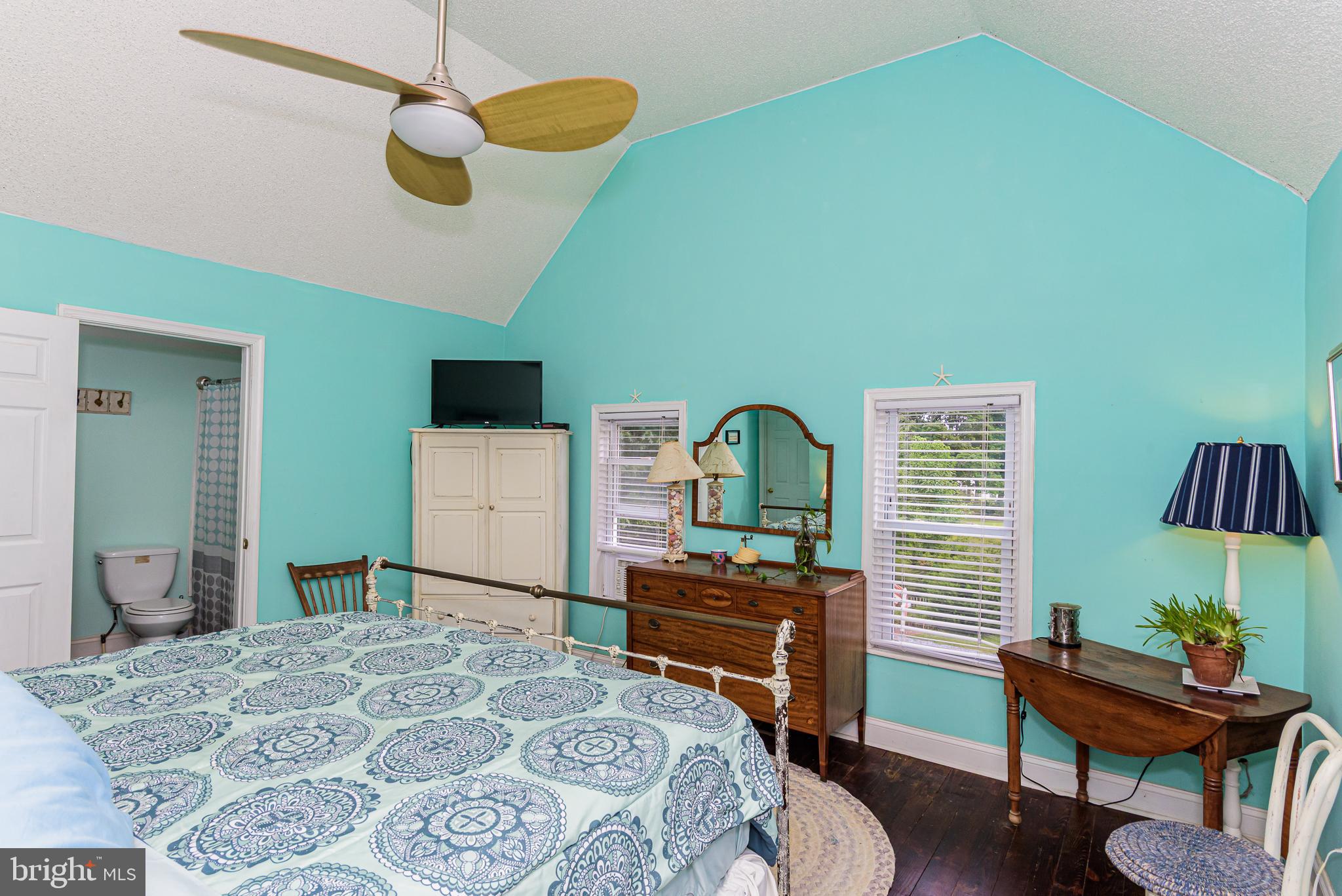 10213 Germantown Road Berlin, MD 21811 - Photo 40 of 118 a bedroom with a bed and a chair