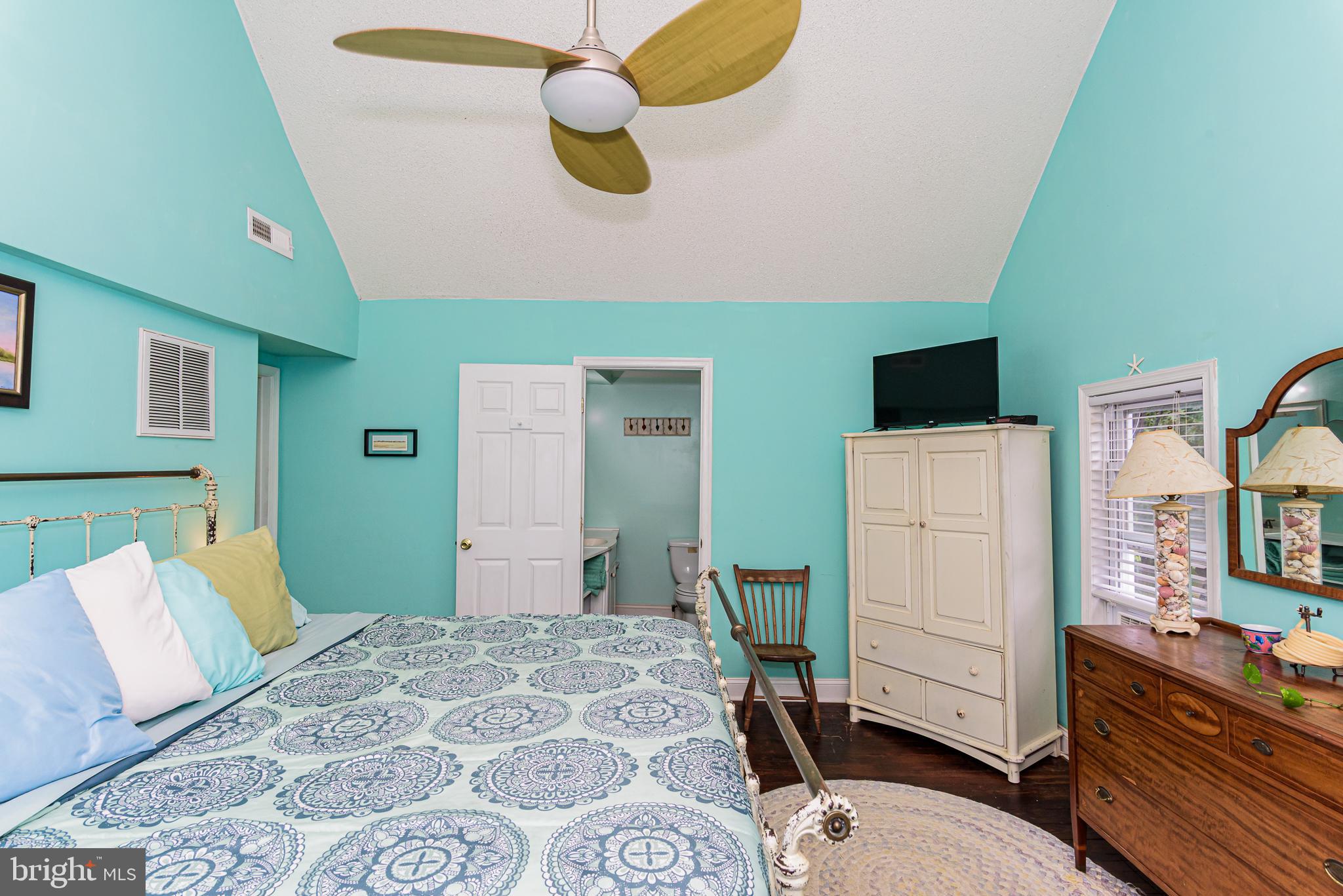 10213 Germantown Road Berlin, MD 21811 - Photo 41 of 118 a bedroom with a bed and wooden floor