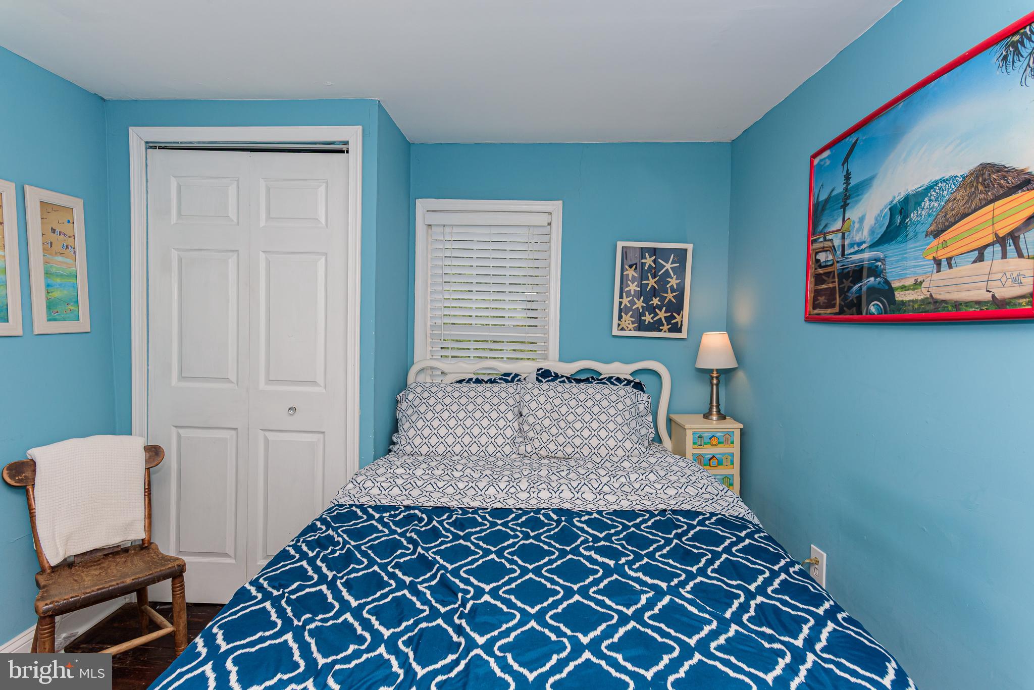 10213 Germantown Road Berlin, MD 21811 - Photo 47 of 118 a bedroom with a bed and painting on the wall