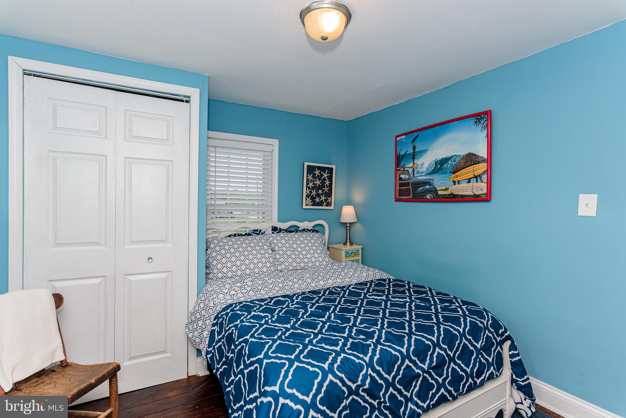 10213 Germantown Road Berlin, MD 21811 - Photo 48 of 118 a bedroom with a bed and painting on the wall