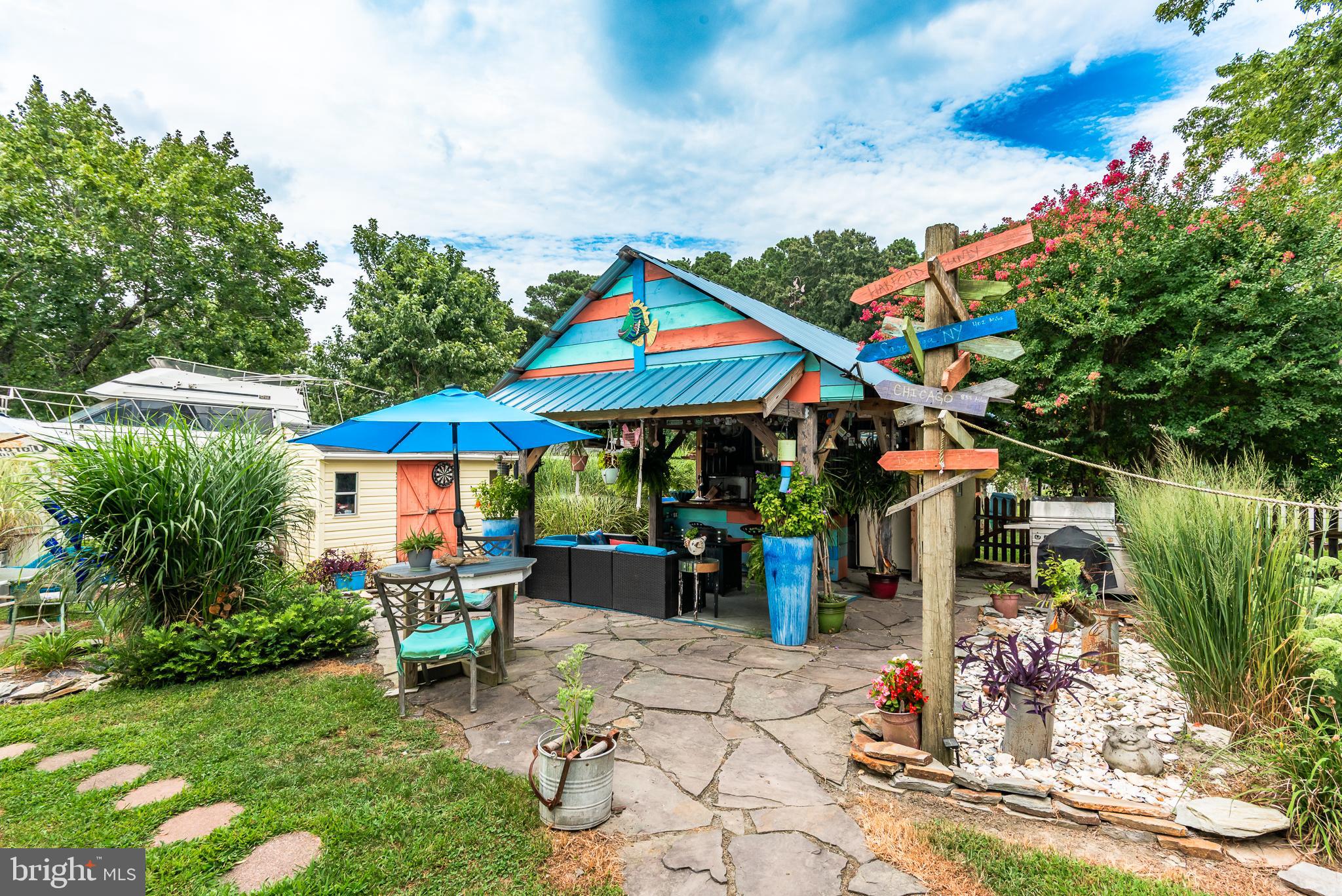 10213 Germantown Road Berlin, MD 21811 - Photo 6 of 118 a patio with a table and chairs under an umbrella