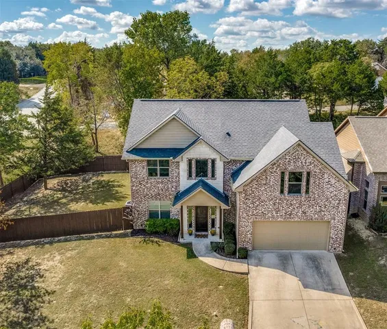 a front view of a house with a yard garage and outdoor seating