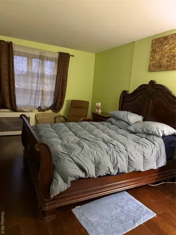 a bedroom with a bed and window