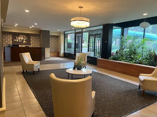 a living room with patio furniture and a potted plant