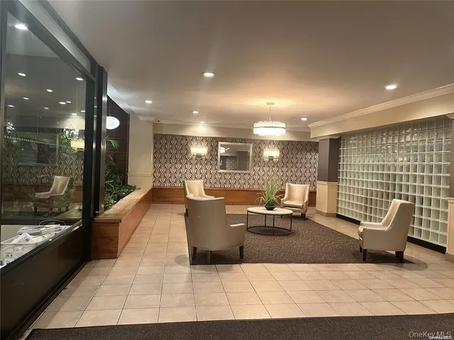 a living room with couches and kitchen view with wooden floor