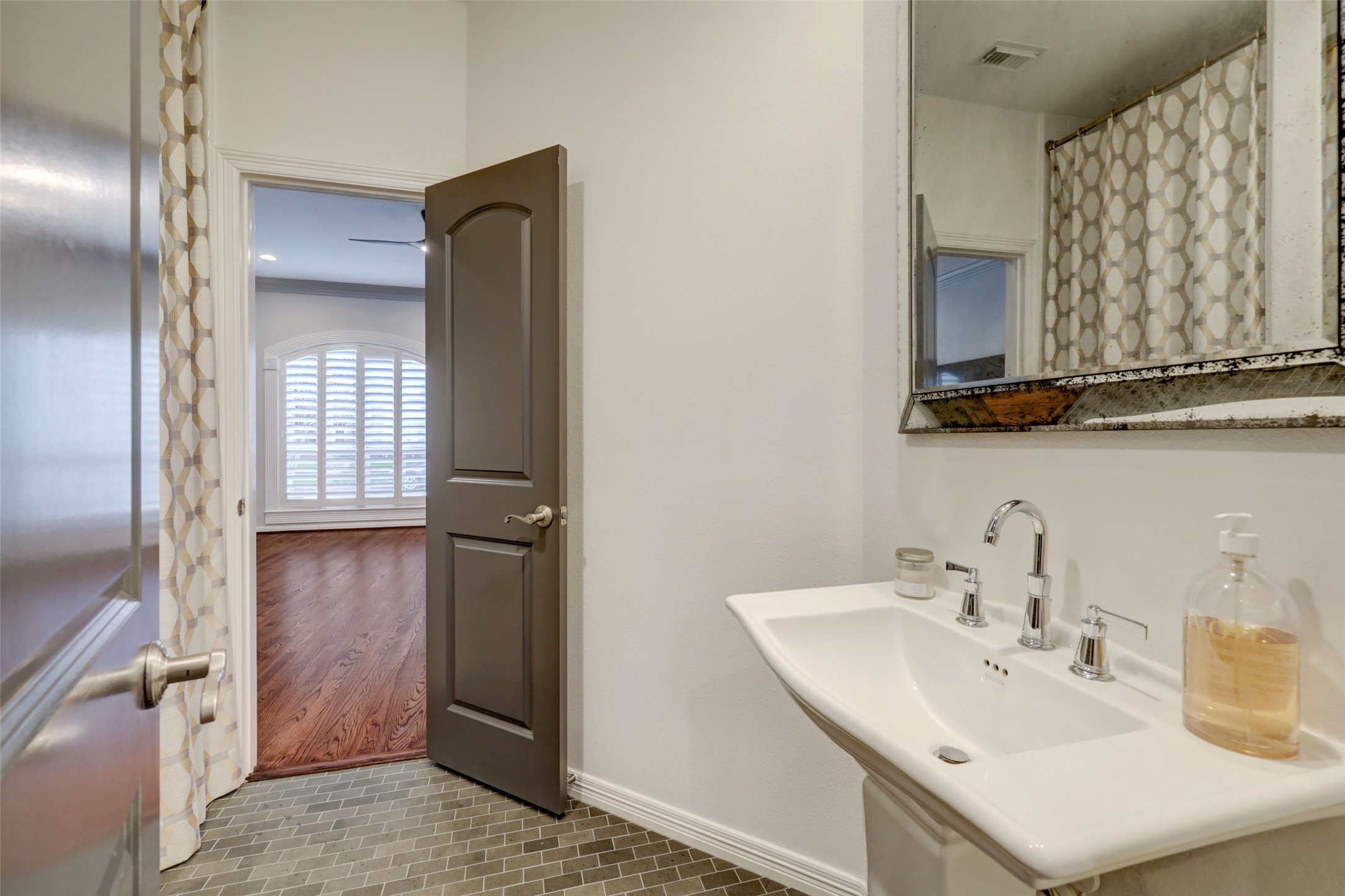 4004 Childress Street Houston, TX 77005 - Photo 11 of 35 a bathroom with a sink a mirror and shower