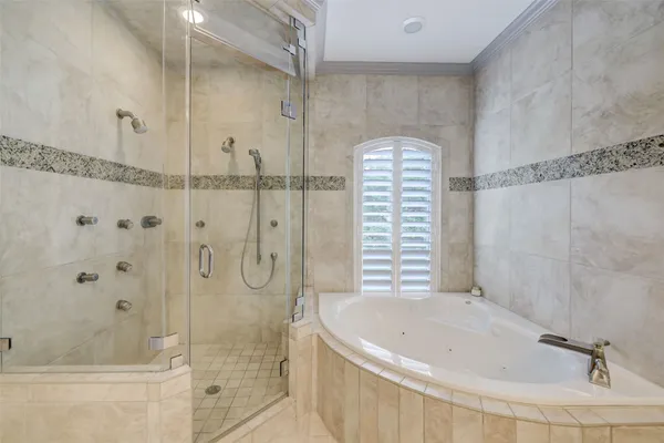 a bathroom with a bathtub and shower