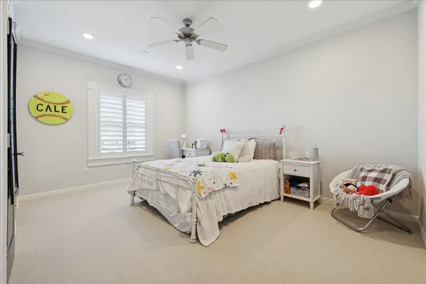 a spacious bedroom with a bed and a window