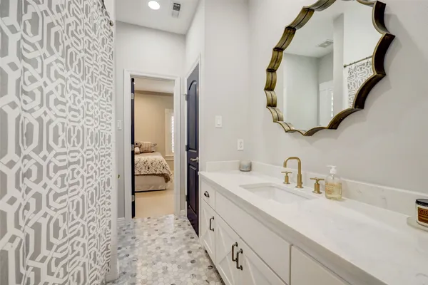 a bathroom with a double vanity sink and mirror