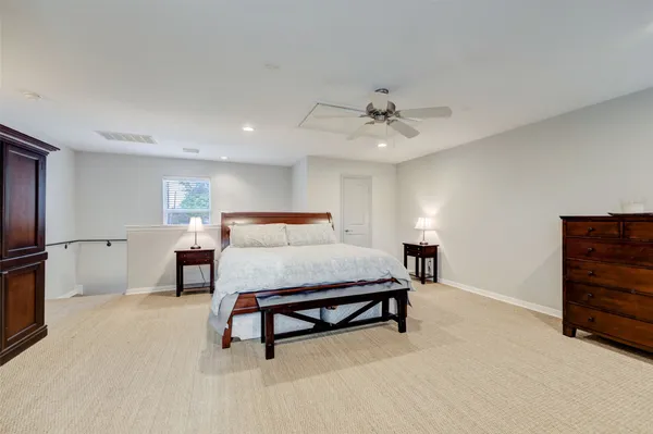 a bedroom with furniture and a lamp