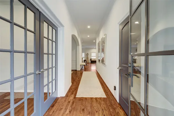 a view of a hallway with wooden floor and staircase